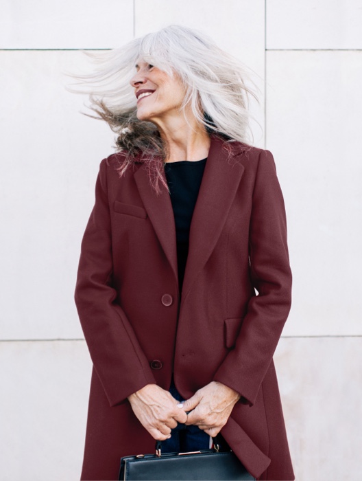 Smiling Senior Woman in a Maroon Coat
